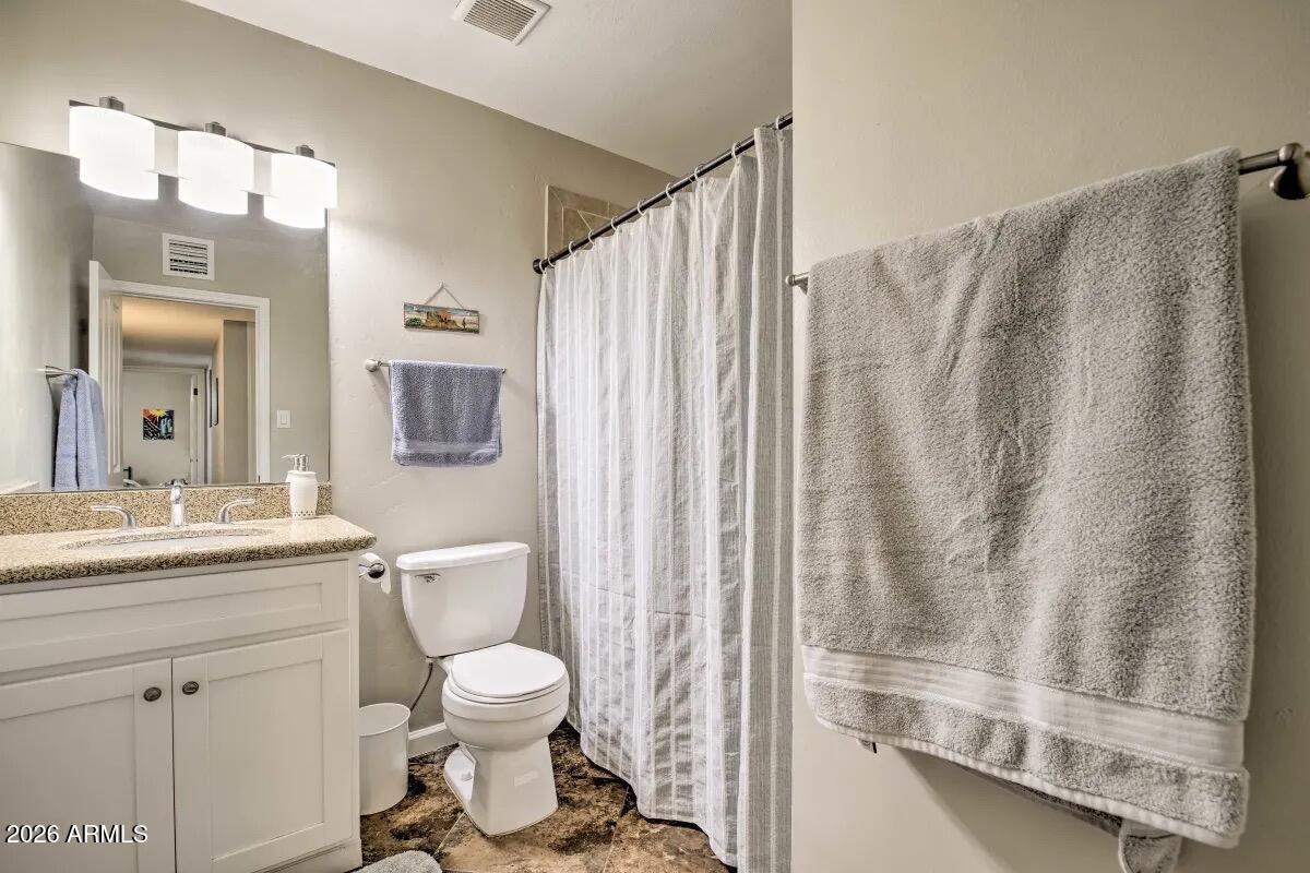609 South Priest Drive Tempe, AZ 85281 - Photo 19 of 29 a bathroom with a granite countertop sink toilet and shower