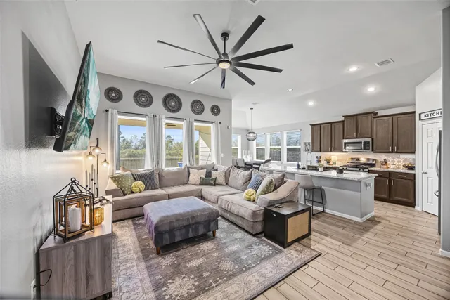 a kitchen with stainless steel appliances granite countertop a stove a sink a refrigerator and a refrigerator