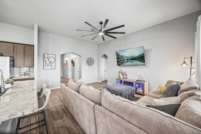 a bedroom with a large bed and a chandelier