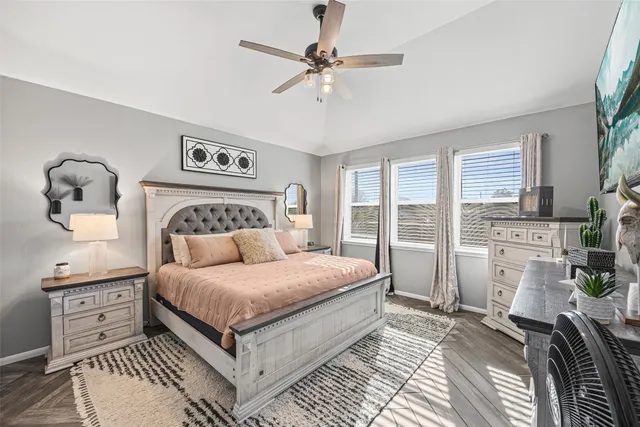 a bedroom with a large bed and a chandelier