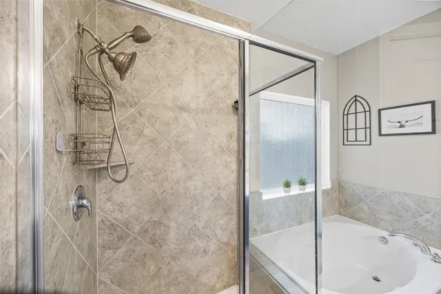 a bathroom with double vanity and a mirror