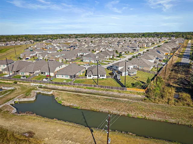 a view of a swimming pool with a chairs and plants