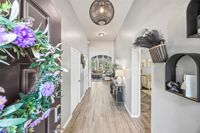 a living room with furniture and a baby crib