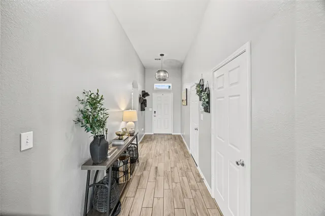 a living room with furniture a large window and a fireplace