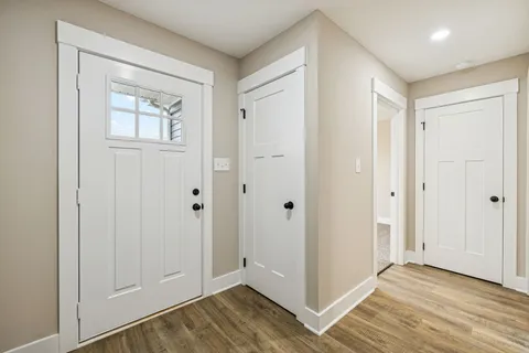 a view of an empty room and wooden floor