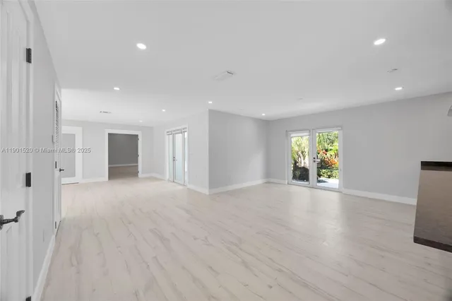 a view of kitchen with sink and refrigerator