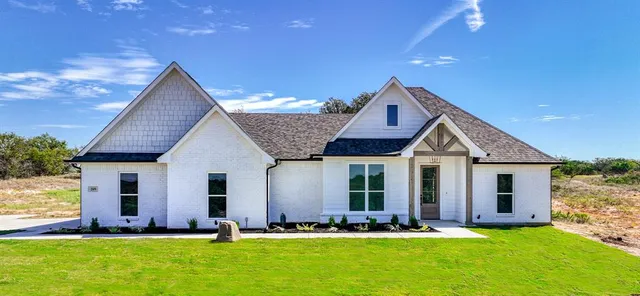 a front view of house with yard and green space