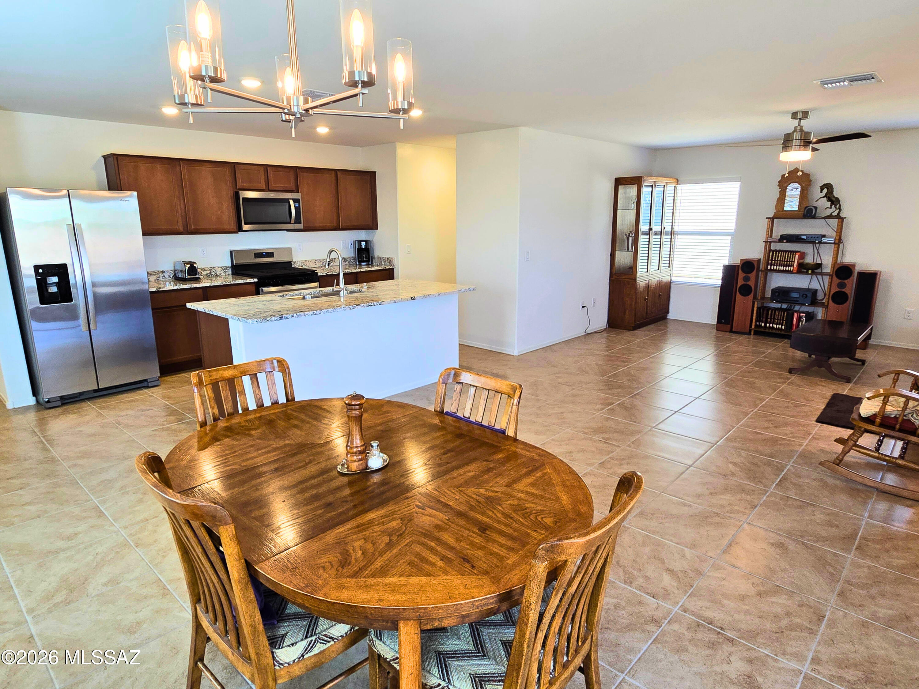 6343 South Rigby Way Tucson, AZ 85746 - Photo 10 of 29 a kitchen with kitchen island a stove and a chandelier