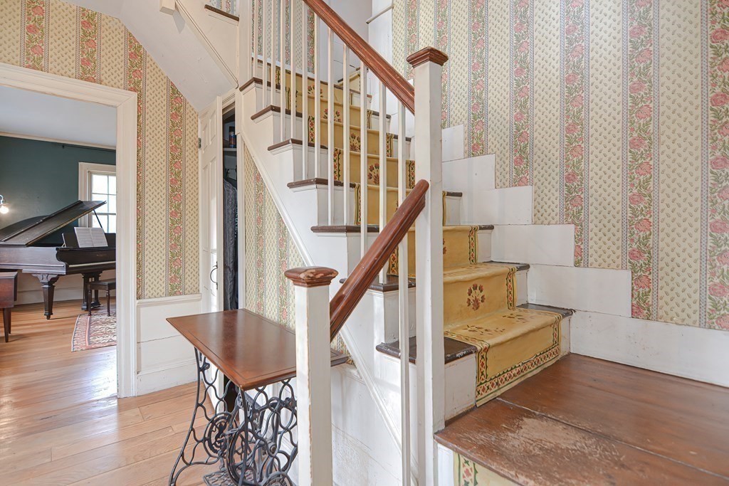58 Hudson Road Sudbury, MA 01776 - Photo 20 of 42 a view of entryway dining room and hall with wooden floor