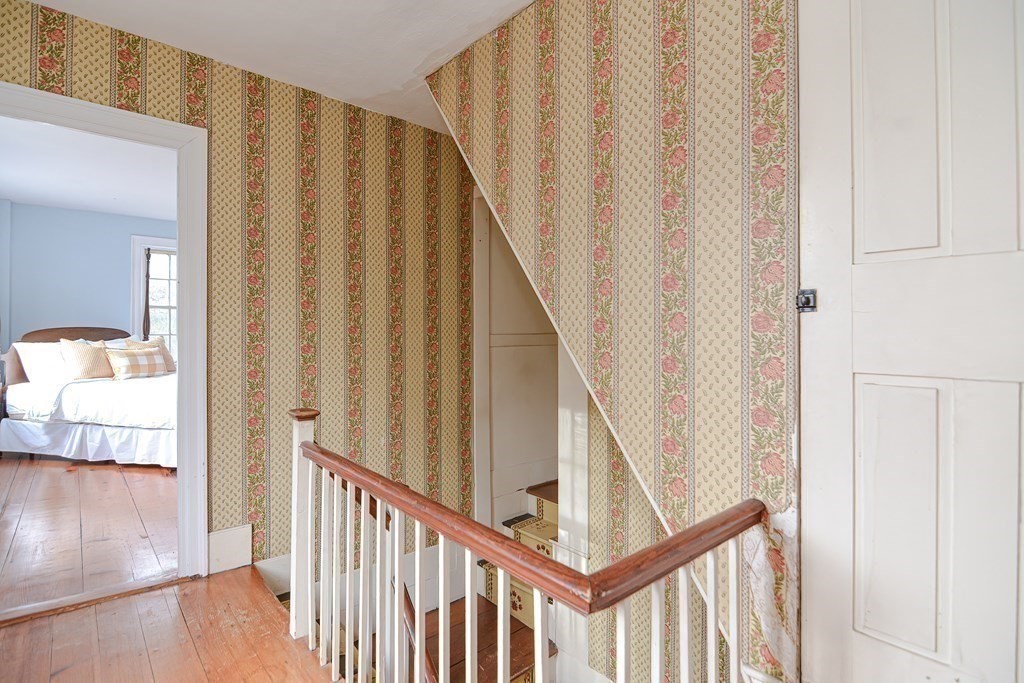 58 Hudson Road Sudbury, MA 01776 - Photo 21 of 42 a view of a hallway with wooden floor and staircase