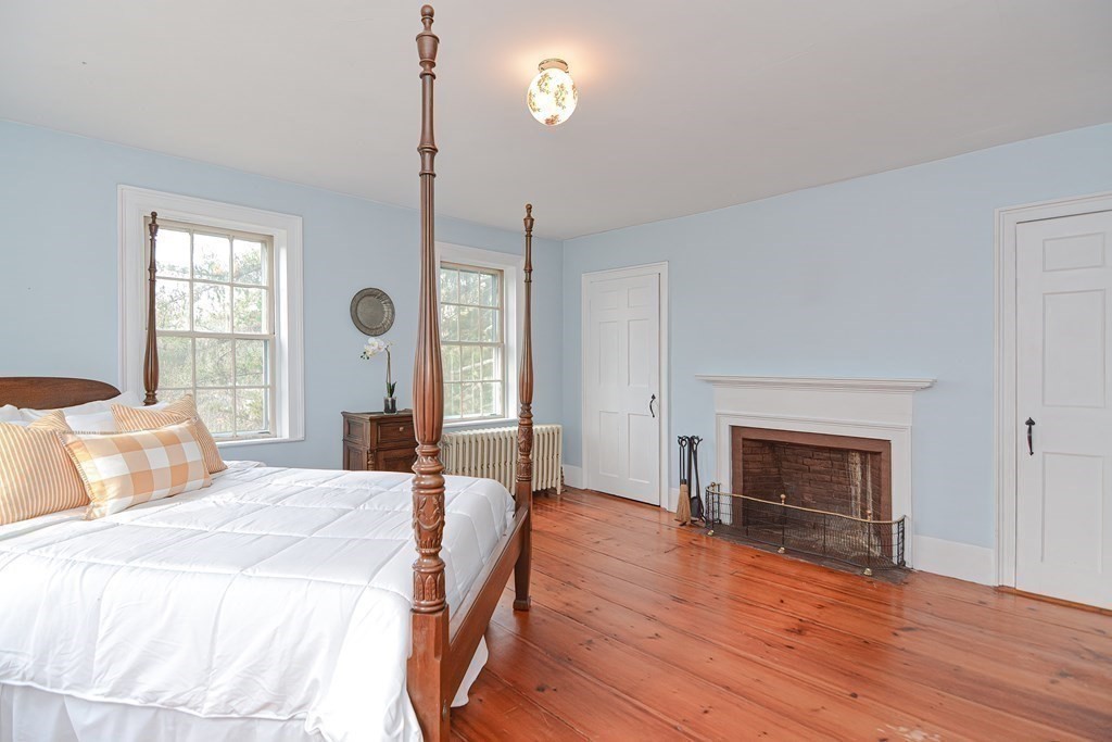 58 Hudson Road Sudbury, MA 01776 - Photo 22 of 42 a bedroom with a bed and a fireplace