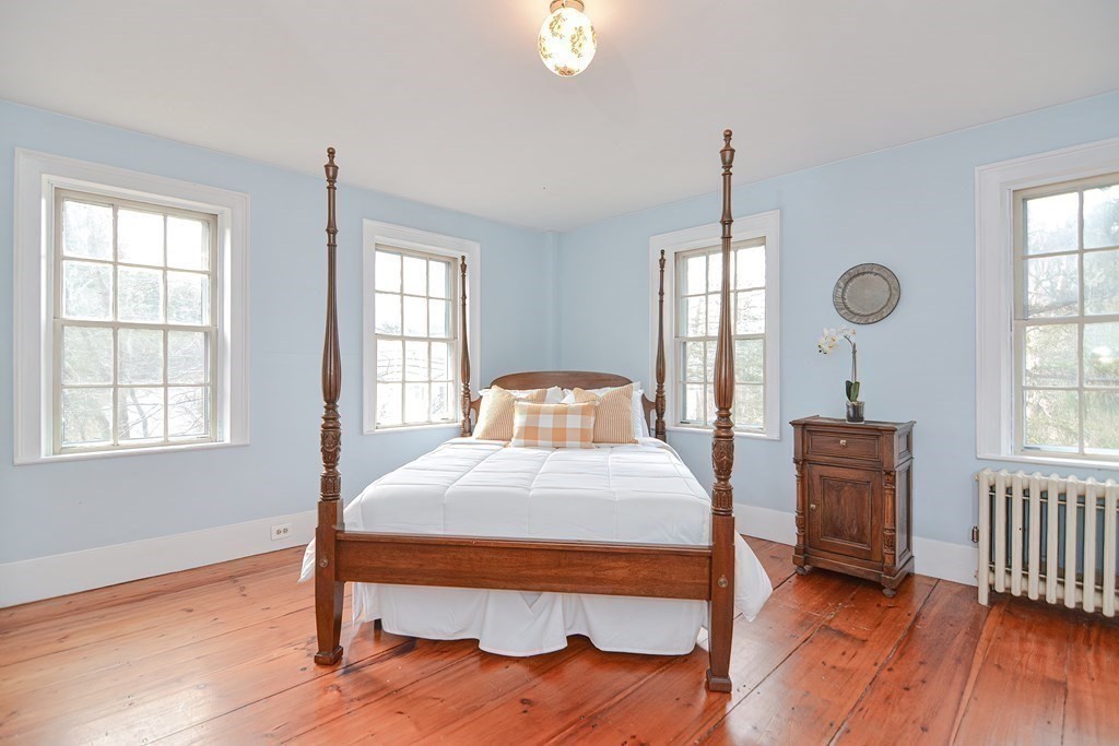 58 Hudson Road Sudbury, MA 01776 - Photo 23 of 42 a bedroom with a bed and wooden floor
