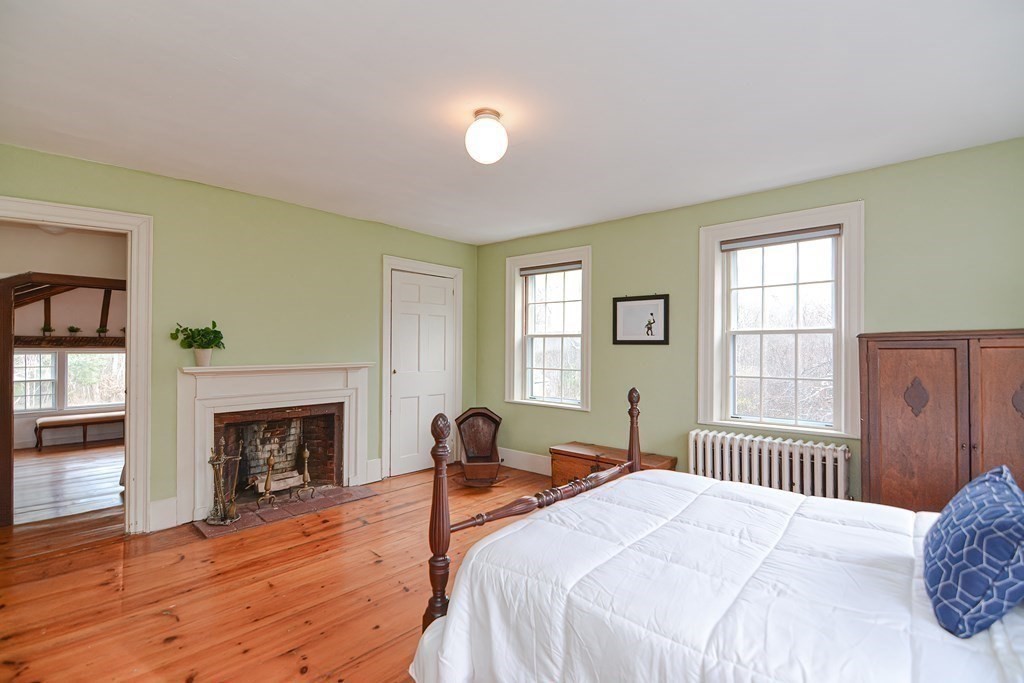 58 Hudson Road Sudbury, MA 01776 - Photo 24 of 42 a bedroom with a bed and a fireplace
