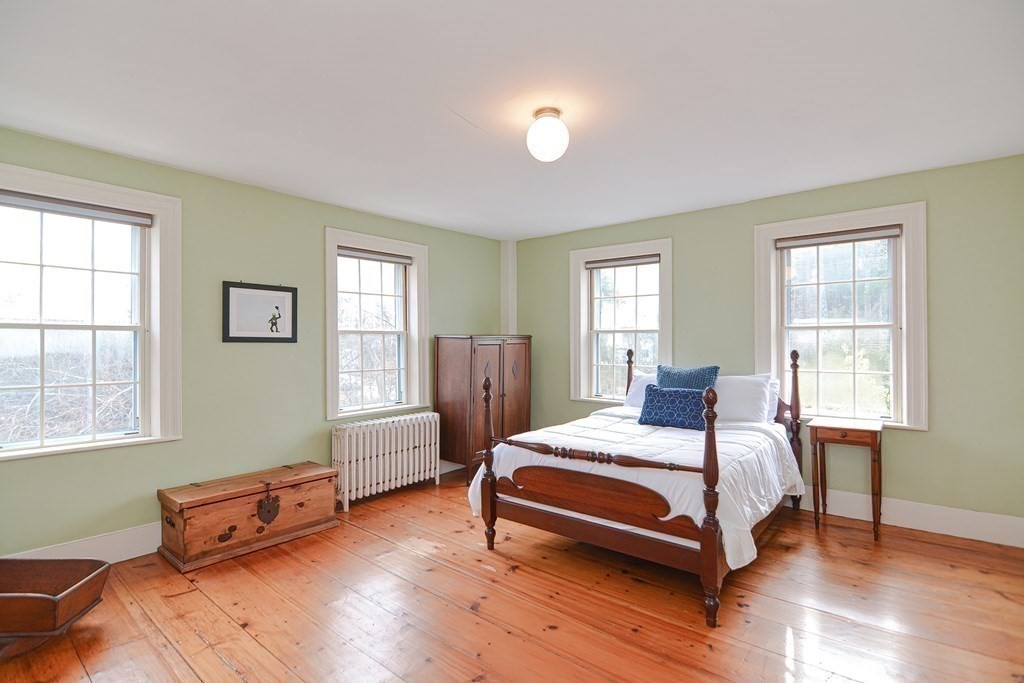 58 Hudson Road Sudbury, MA 01776 - Photo 25 of 42 a bedroom with a bed and wooden floor