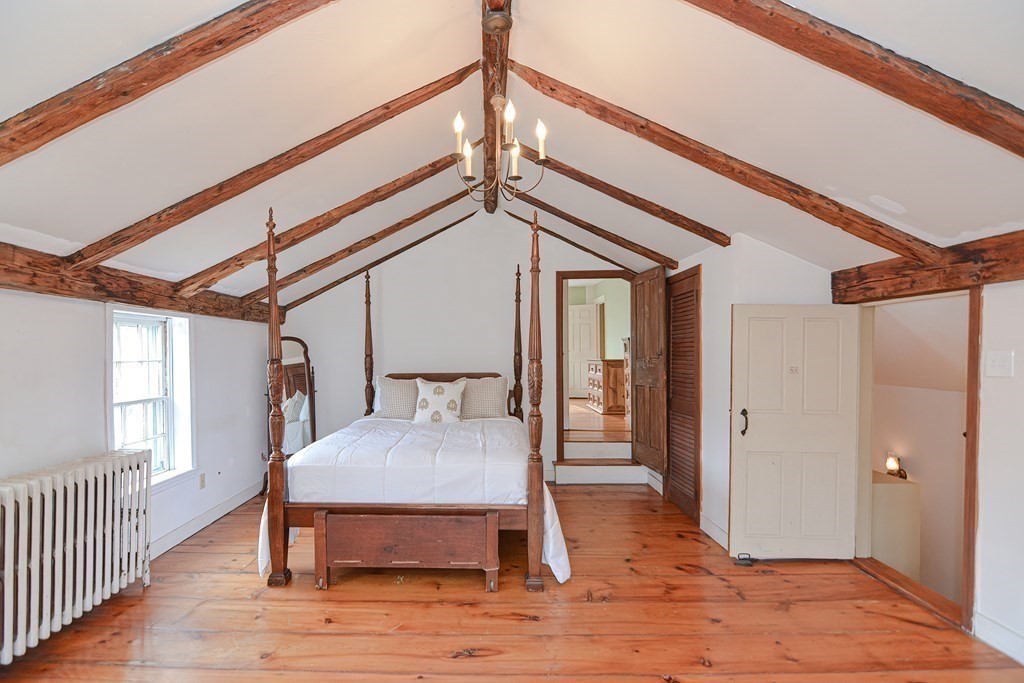 58 Hudson Road Sudbury, MA 01776 - Photo 26 of 42 a bedroom with wooden floor and a bed