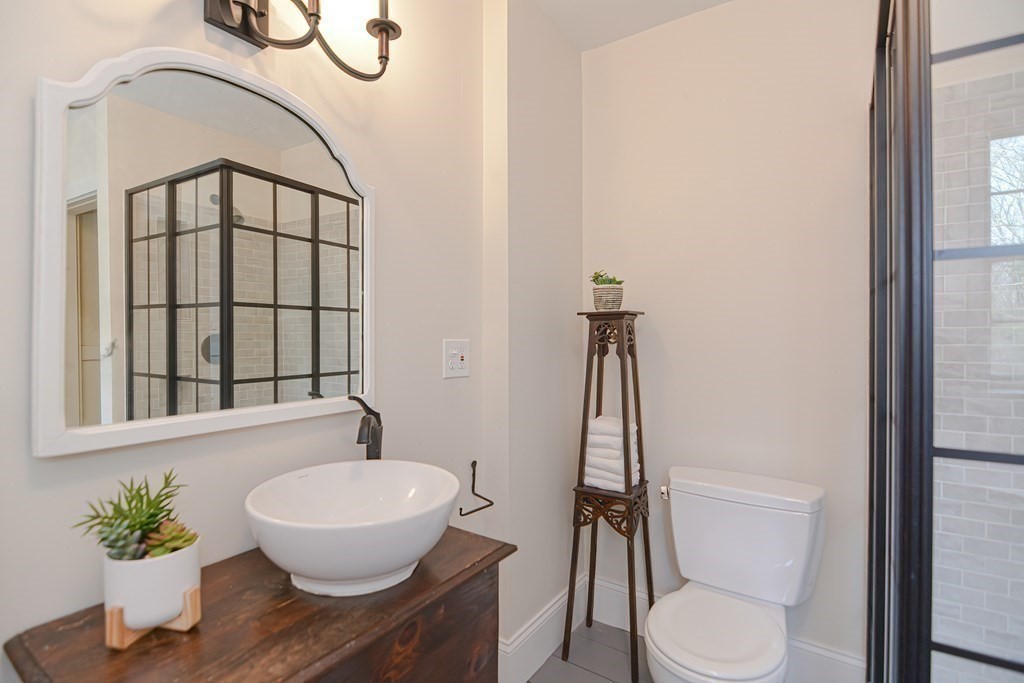 58 Hudson Road Sudbury, MA 01776 - Photo 29 of 42 a bathroom with a toilet a sink and a window