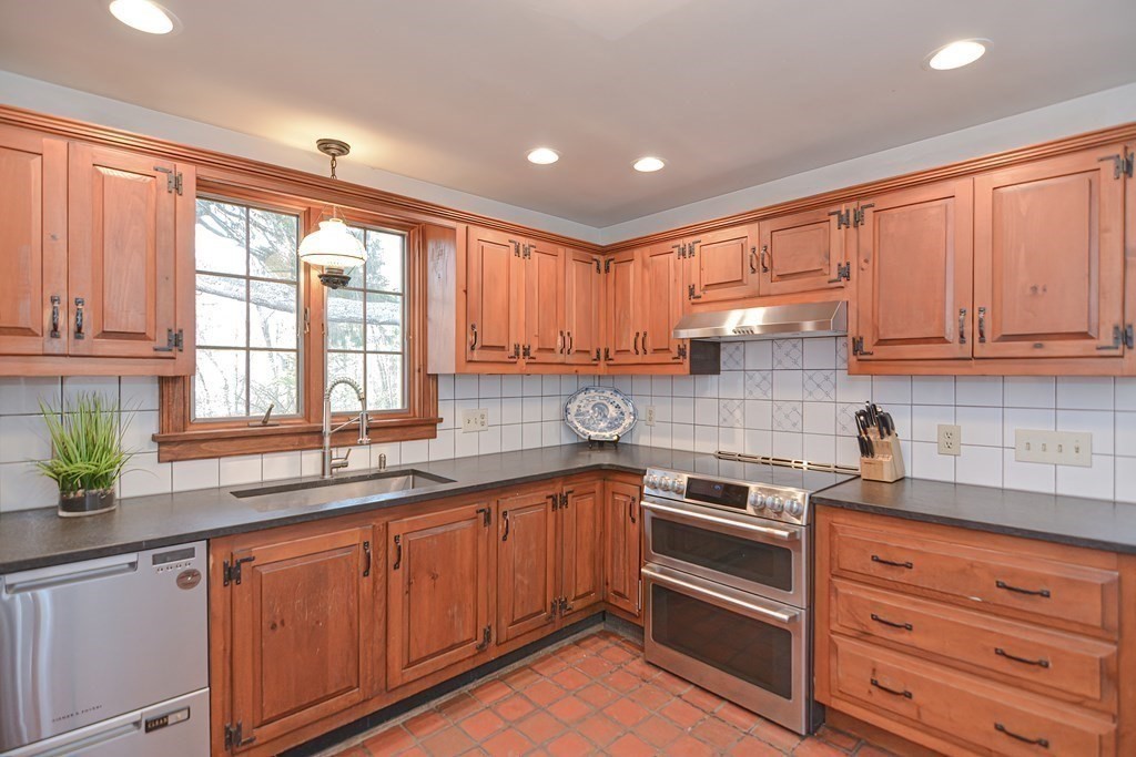 58 Hudson Road Sudbury, MA 01776 - Photo 4 of 42 a kitchen with stainless steel appliances granite countertop a sink a stove and cabinets
