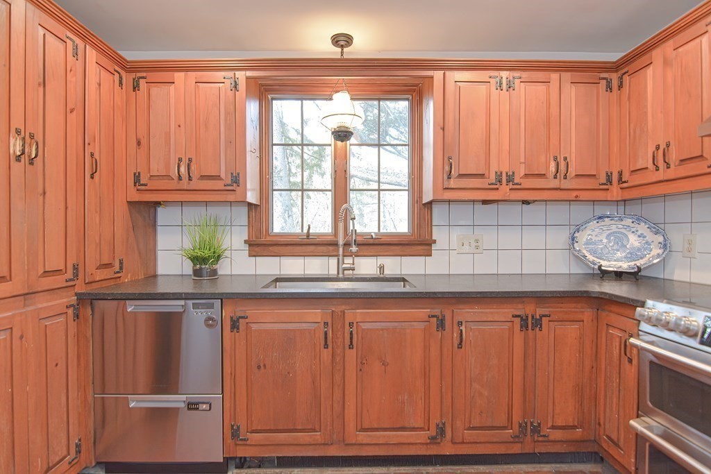 58 Hudson Road Sudbury, MA 01776 - Photo 5 of 42 a kitchen with granite countertop wooden cabinets and a window