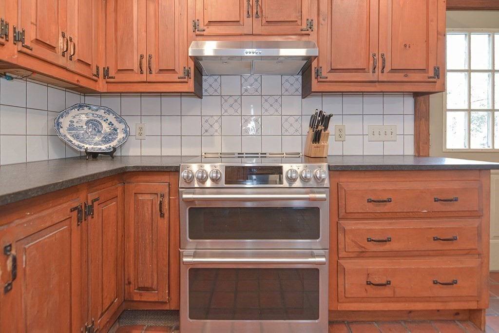 58 Hudson Road Sudbury, MA 01776 - Photo 6 of 42 a stove top oven sitting inside of a kitchen