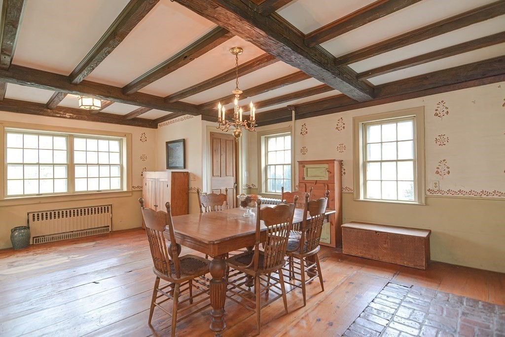 58 Hudson Road Sudbury, MA 01776 - Photo 9 of 42 a dining room with furniture a chandelier and wooden floor