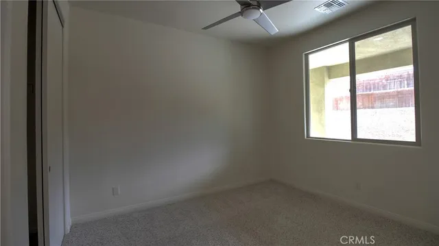 a view of empty room with a ceiling fan