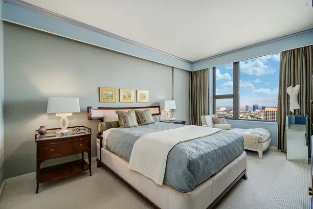 a bedroom with a bed and a night stand