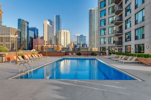 a view of a swimming pool with outdoor seating