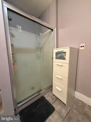 a bathroom with a shower and a sink