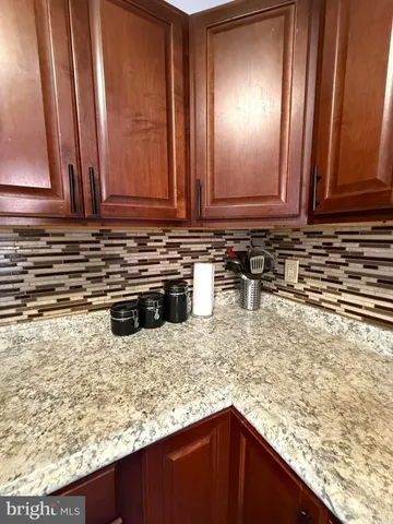 a kitchen with granite countertop a sink and a stove