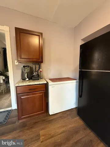 a kitchen with a refrigerator and a stove top oven