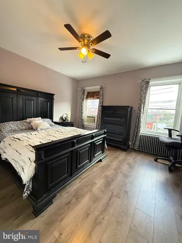 a bed room with a bed and a ceiling fan