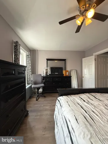 a bedroom with furniture and a flat screen tv
