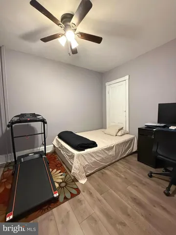 a bedroom with a bed and a ceiling fan