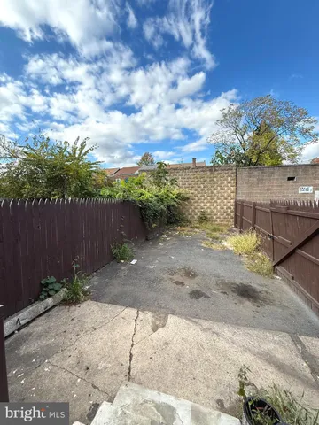 a view of a pathway with a wrought fence