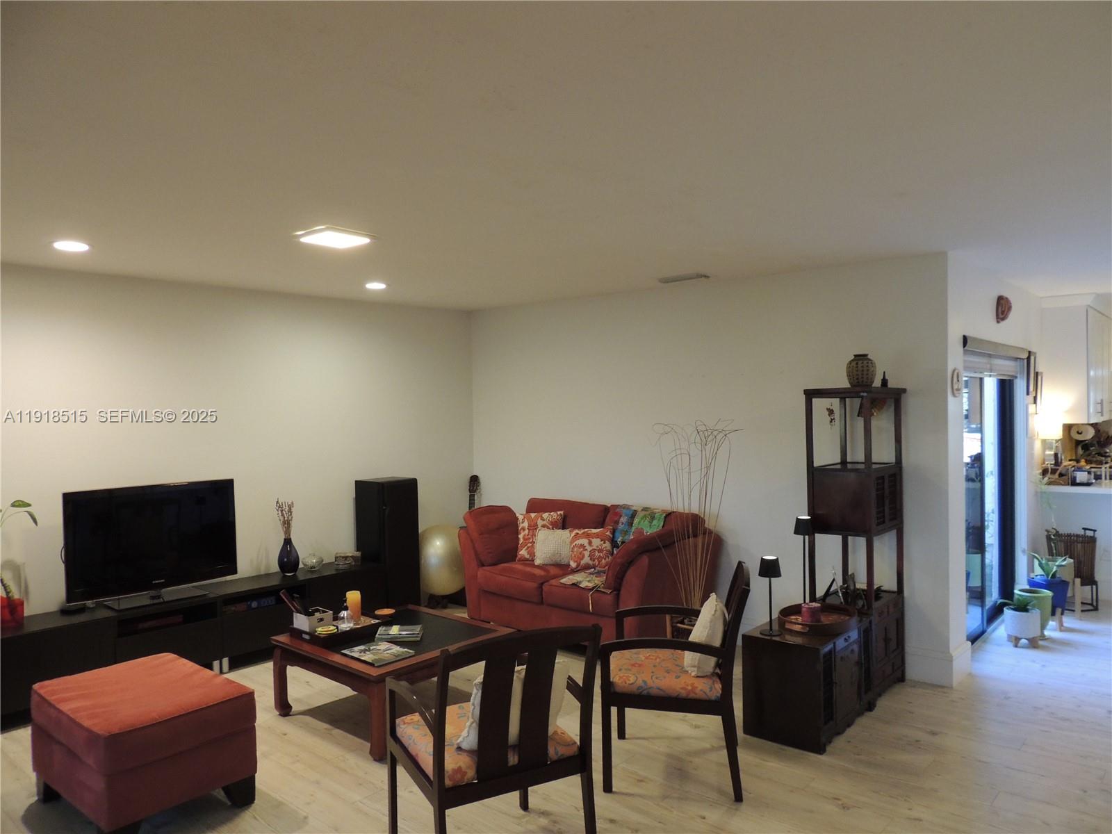 7951 Eastlake Drive, Unit C Boca Raton, FL 33433 - Photo 17 of 46 a living room with furniture and a flat screen tv