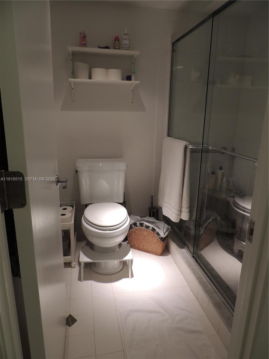 7951 Eastlake Drive, Unit C Boca Raton, FL 33433 - Photo 25 of 46 a bathroom with a toilet and a shower