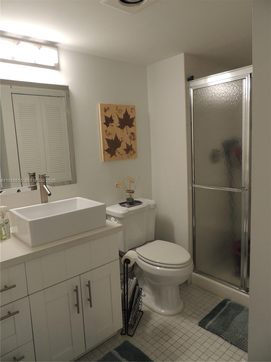 7951 Eastlake Drive, Unit C Boca Raton, FL 33433 - Photo 29 of 46 a bathroom with a sink toilet and shower