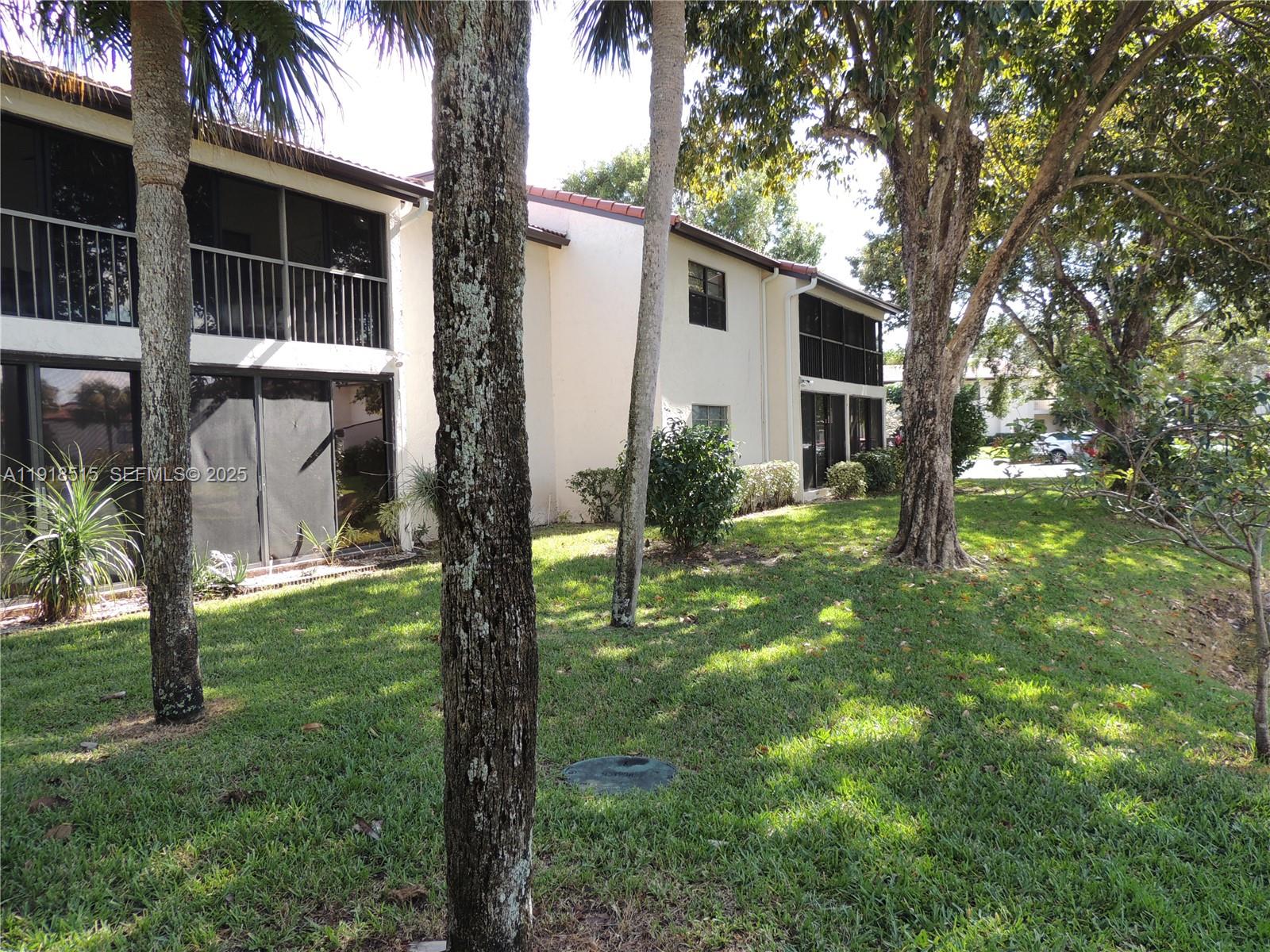 7951 Eastlake Drive, Unit C Boca Raton, FL 33433 - Photo 36 of 46 a view of backyard of house with green space