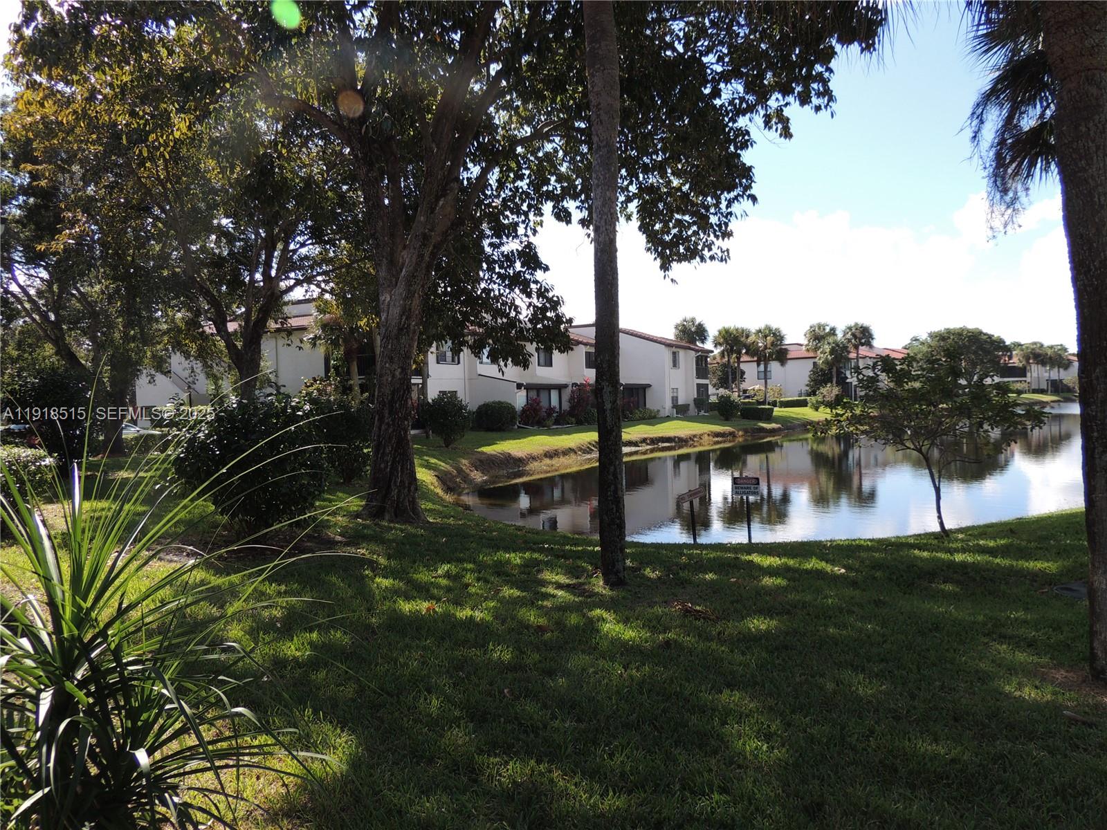 7951 Eastlake Drive, Unit C Boca Raton, FL 33433 - Photo 37 of 46 a view of a lake from a yard