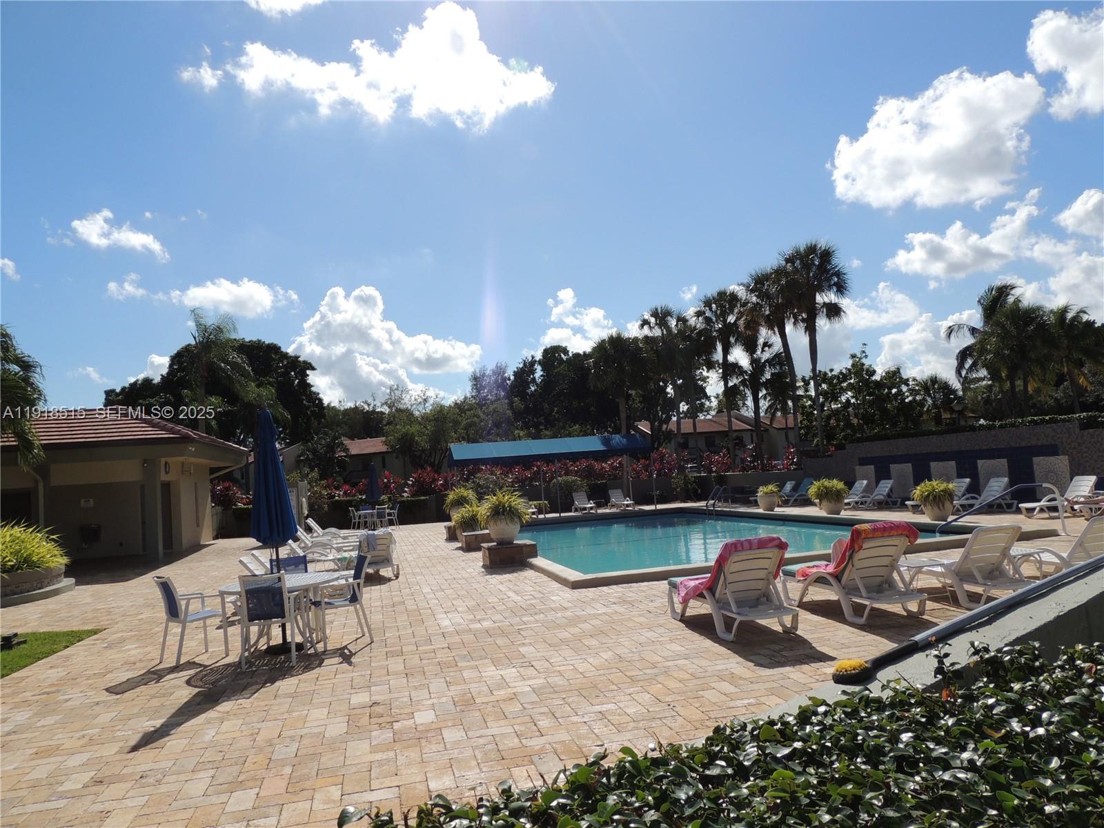 7951 Eastlake Drive, Unit C Boca Raton, FL 33433 - Photo 42 of 46 a view of a chairs and tables in the patio
