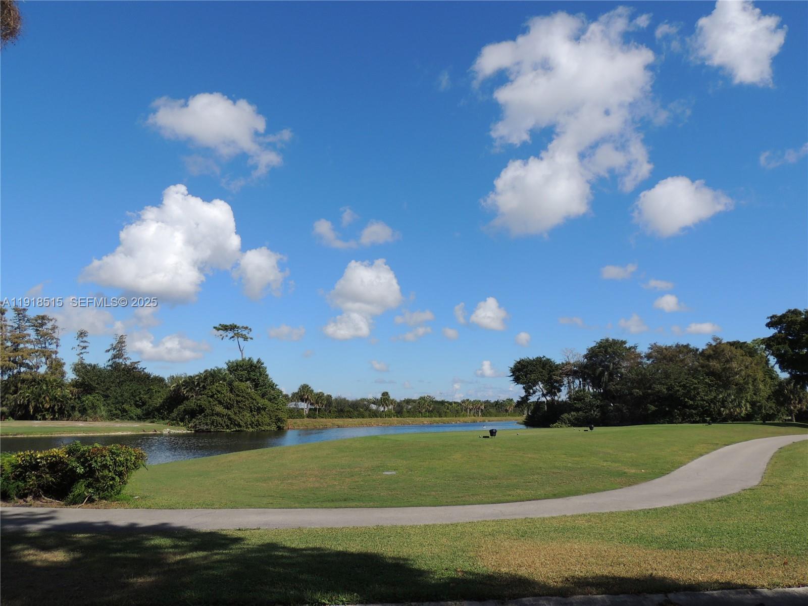 7951 Eastlake Drive, Unit C Boca Raton, FL 33433 - Photo 43 of 46 a view of a lake and yard