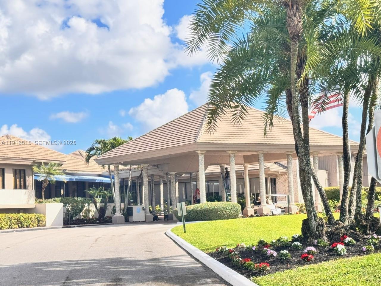 7951 Eastlake Drive, Unit C Boca Raton, FL 33433 - Photo 5 of 46 a view of a white house with a swimming pool and outdoor seating