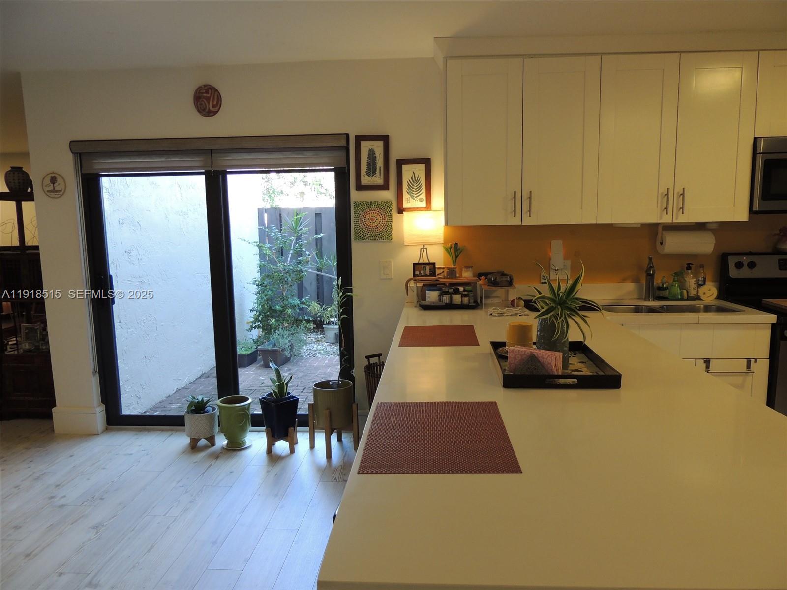 7951 Eastlake Drive, Unit C Boca Raton, FL 33433 - Photo 7 of 46 a room with furniture and wooden floor