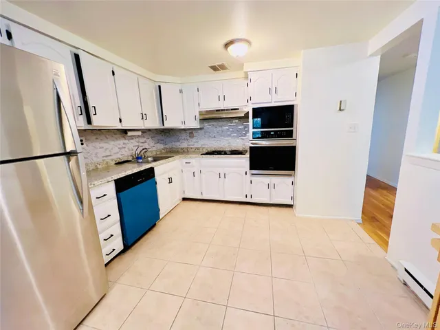 a kitchen with stainless steel appliances a refrigerator sink and microwave