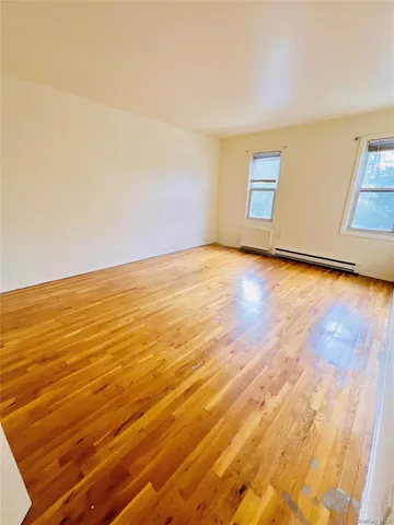 a view of an empty room and wooden floor
