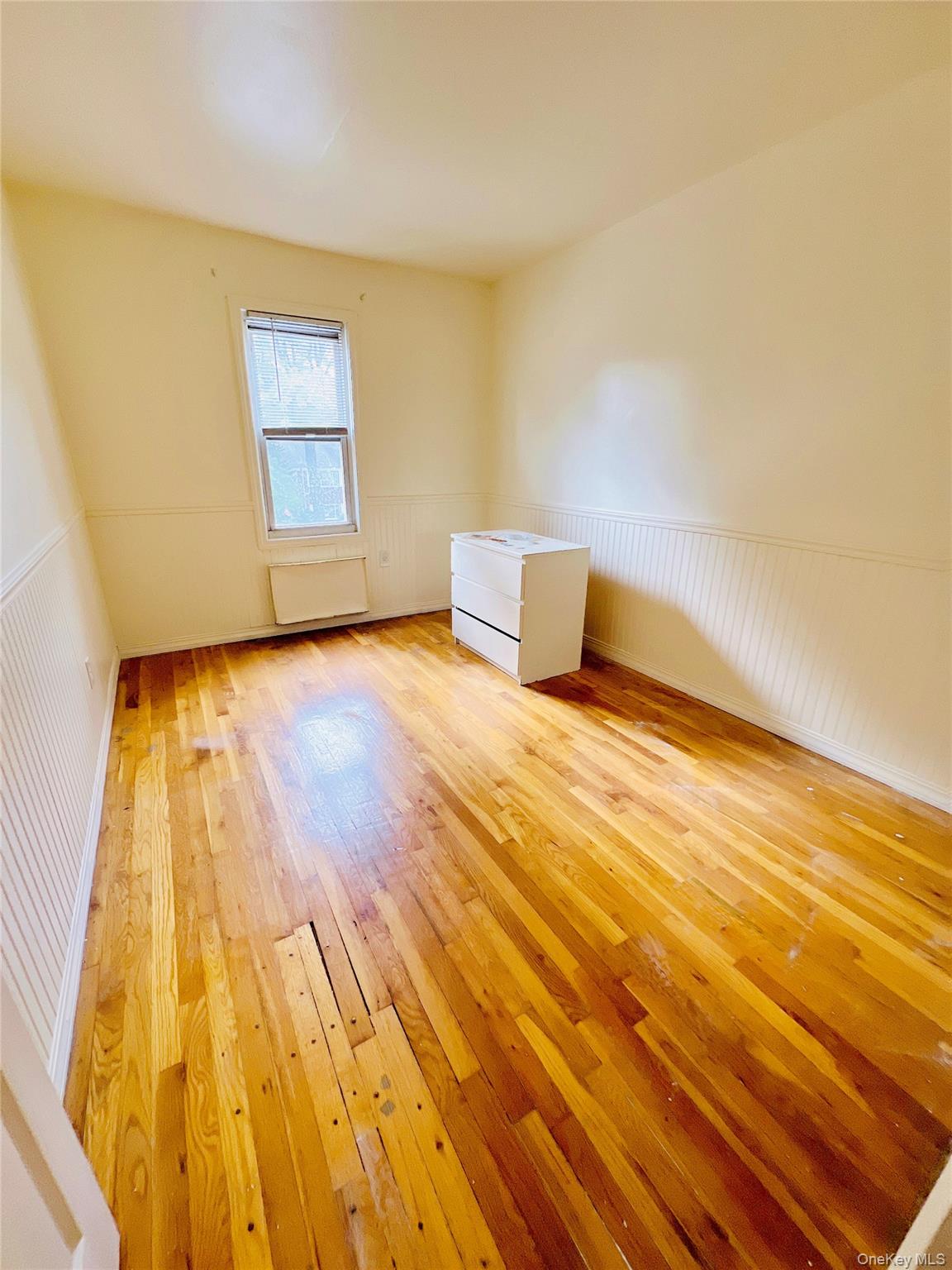 13-27 Bell Boulevard, Unit 3F Queens, NY 11360 - Photo 8 of 11 a view of an empty room and wooden floor