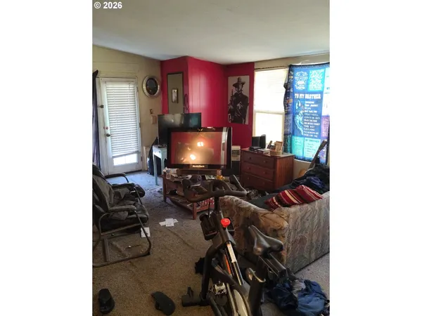 a room with furniture a bookshelf and a window