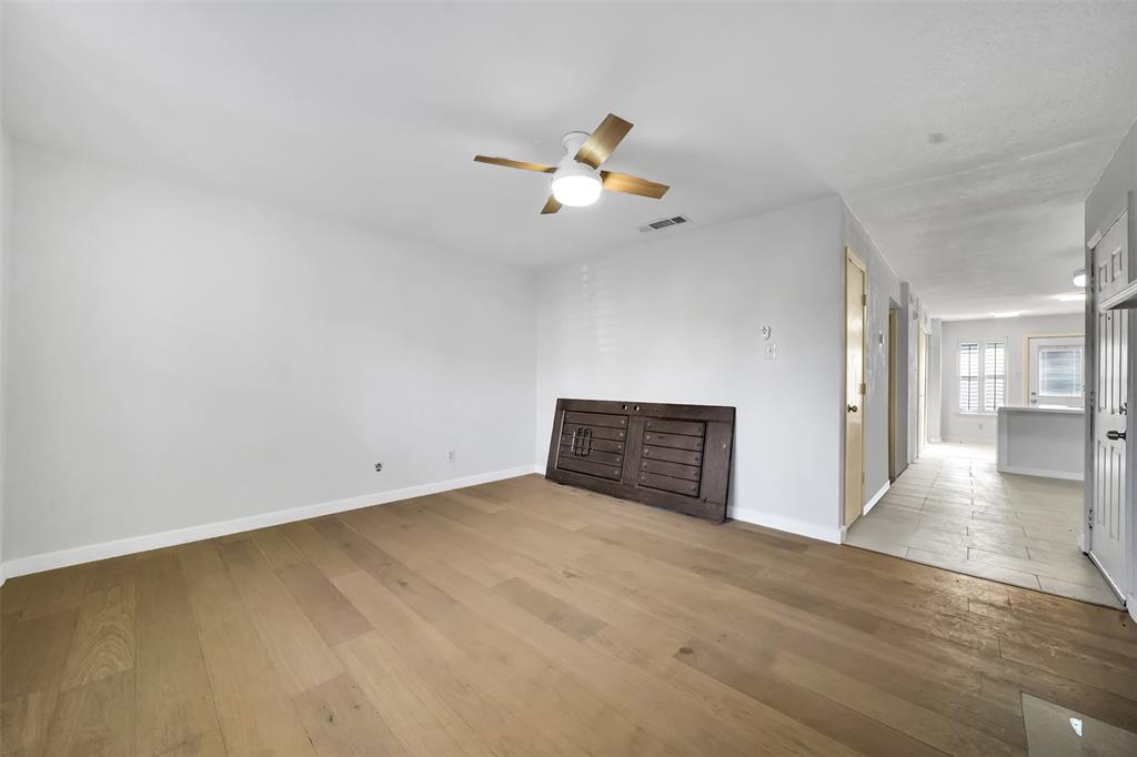2111 East Belt Line Road, Unit 166B Richardson, TX 75081 - Photo 12 of 23 Unfurnished living room featuring light wood-type flooring and a ceiling fan
