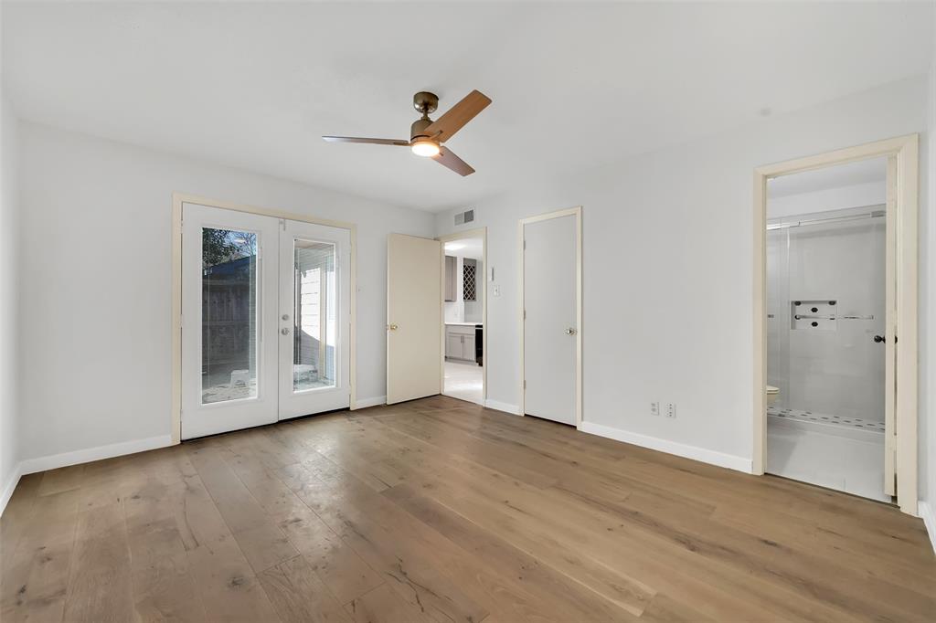 2111 East Belt Line Road, Unit 166B Richardson, TX 75081 - Photo 14 of 23 Unfurnished bedroom with ensuite bath, access to exterior, ceiling fan, and french doors