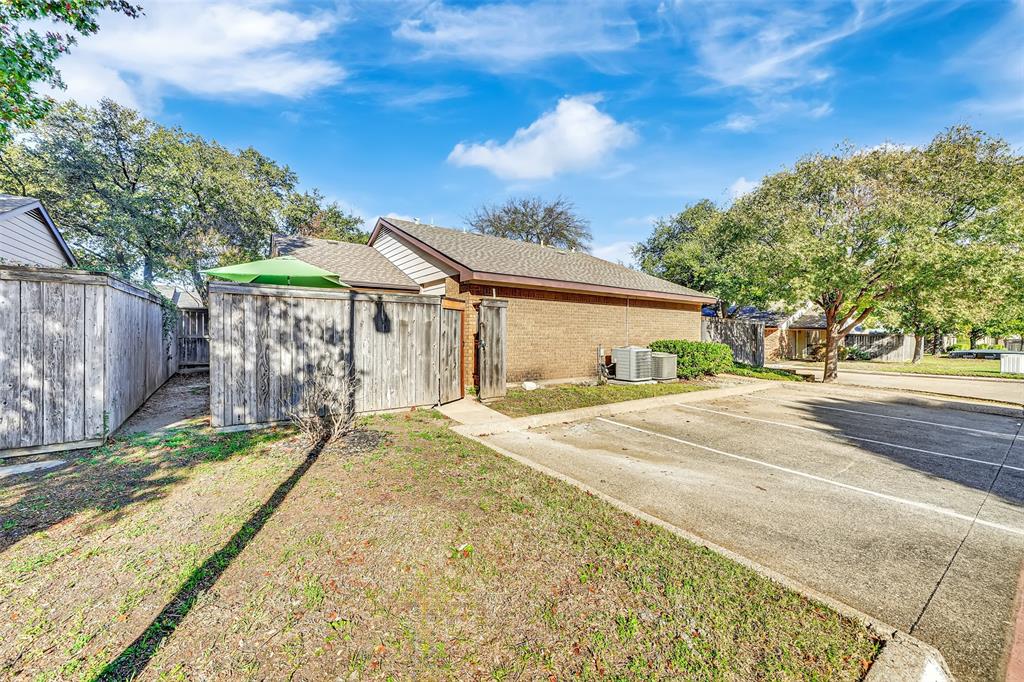 2111 East Belt Line Road, Unit 166B Richardson, TX 75081 - Photo 23 of 23 View of home's exterior featuring uncovered parking, brick siding, and a shingled roof